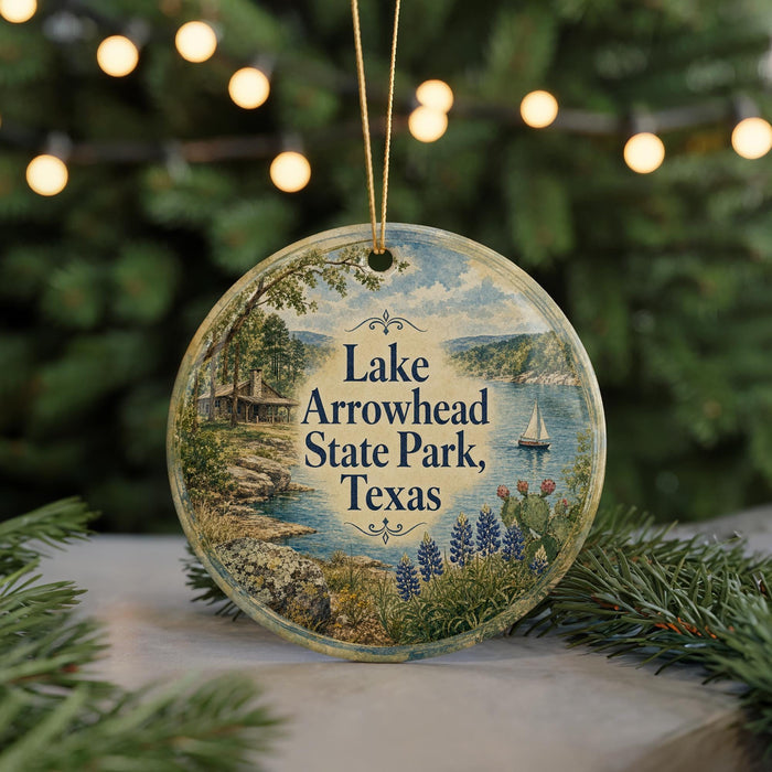 A circular ornament with a scenic image of Lake Arrowhead State Park, Texas, surrounded by greenery and a sailboat.