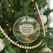 A round ornament hanging on a Christmas tree, featuring a scenic image of Lake Carmi State Park in Vermont.