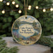 A round ornament with a scenic landscape of Lake Francis State Park, New Hampshire, featuring a lake, mountains, pine trees, and a boat on the water.
