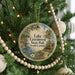 A round ornament hanging on a Christmas tree, featuring a scenic image of Lake Greenwood State Park in South Carolina.