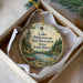 A round ornament with a scenic landscape of Lake Hiddenwood State Recreation Area, South Dakota, featuring a lake, trees, and a cabin.