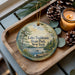 A decorative ornament with a scenic lake and forest landscape, featuring the text "Lake Taghkanic State Park, New York".