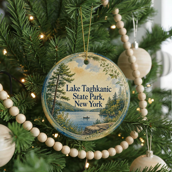 A round ornament hanging on a Christmas tree, featuring a scenic landscape with a lake and pine trees.