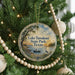 A round ornament hanging on a Christmas tree, featuring a scenic image of Lake Tawakoni State Park, Texas.