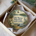 A round ornament with a scenic image of Lake Warren State Park, South Carolina, featuring a bird, a boat, and a lake surrounded by trees.