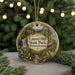 A circular ornament featuring a scenic image of Laurel Hill State Park in Pennsylvania, with a waterfall and a cabin in the background.