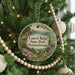 A round ornament hanging on a Christmas tree, featuring a scenic image of Laurel Ridge State Park in Pennsylvania.