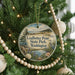 A round ornament hanging on a Christmas tree, featuring a scenic image of Leadsbetter Point State Park in Washington.