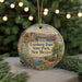 A round ornament with a painting of Leasburg Dam, a waterway, and a scenic landscape in New Mexico.
