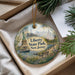 A decorative ornament featuring the Statue of Liberty and Liberty State Park in New Jersey, with a pine branch and greenery in the background.