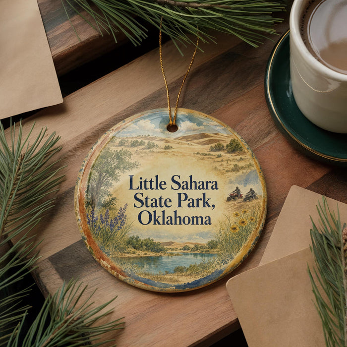 A decorative ornament with a scenic landscape of Little Sahara State Park, Oklahoma, featuring a lake, mountains, and pine trees.