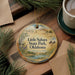 A decorative ornament with a scenic landscape of Little Sahara State Park, Oklahoma, featuring a lake, mountains, and pine trees.