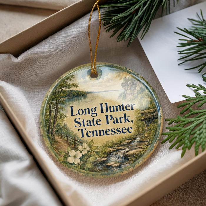 A decorative ornament with a scenic landscape of Long Hunter State Park, Tennessee, featuring a waterfall and pine trees.