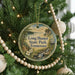 A round ornament hanging on a Christmas tree, featuring a scenic landscape of Long Hunter State Park, Tennessee.