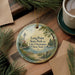 A decorative ornament featuring a lighthouse and a scenic lake, with the text "Long Point State Park on Lake Chautauqua New York" displayed on it.