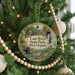 A round ornament hanging on a Christmas tree, featuring an illustration of Lost River State Park in West Virginia.