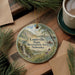 A decorative ornament featuring a scenic landscape of the Louisville State Recreation Area in Nebraska, with a waterfall and a person kayaking in the background.