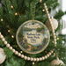 A round ornament hanging on a Christmas tree, featuring a scenic image of Madison Lake State Park, Ohio.
