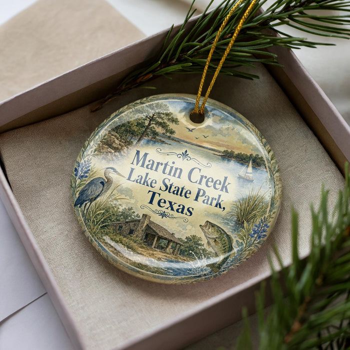A decorative ornament in a box, featuring a scenic image of Martin Creek Lake State Park, Texas.