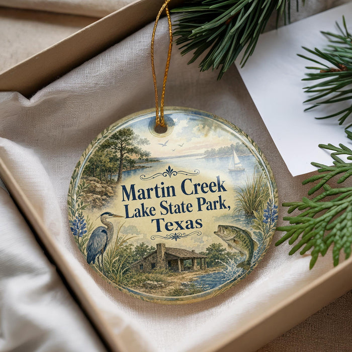 A decorative ornament with a scenic image of Martin Creek Lake State Park, Texas, featuring a bird, a house, and a fish.