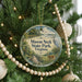 A round ornament hanging on a Christmas tree, featuring a scenic image of Mason Neck State Park, Virginia.