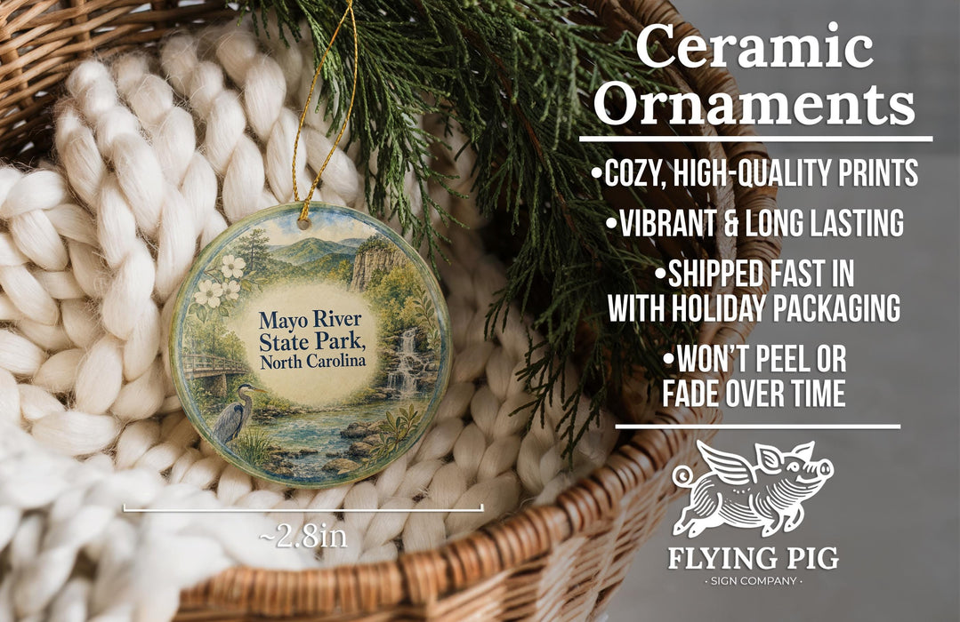 Ceramic ornaments, featuring a nature scene with a bird and a waterfall, are displayed in a woven basket.