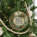 A round ornament hanging on a Christmas tree, featuring a scenic image of Mill Pond State Park in North Carolina.