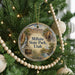 A round ornament hanging on a Christmas tree, featuring a scenic image of Millsite State Park in Utah.
