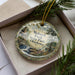 A decorative ornament with a scenic image of Mohawk Park, Oklahoma, featuring a waterfall and pine trees.