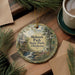 A round ornament with a scenic image of Mohawk Park, Oklahoma, hanging on a wooden surface.