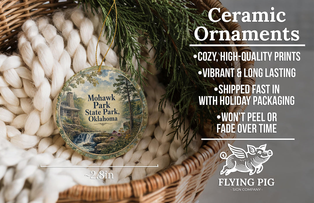 Ceramic ornaments, including a round ornament with a scenic image of Mohawk Park, Oklahoma, hanging from a wicker basket.