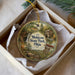 A decorative ornament in a box, featuring a scenic image of Mohican State Park, Ohio.