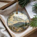 A decorative ornament with a scenic mountain landscape and pine trees, featuring the text "Monadnock State Park, New Hampshire" and a trail sign.
