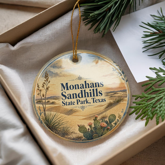 A decorative ornament with a landscape scene featuring sand hills, cacti, and pine trees, along with the text "Monahans Sandhills State Park, Texas".