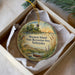 A round ornament with a scenic landscape and a bird is displayed in a box, with the text "M Mormon Island State Recreation Area, Nebraska" printed on it.