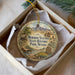 A decorative ornament in a box, featuring a scenic landscape with mountains, a river, and a small wagon, along with the text "M Mormon Station State Historic Park, Nevada".