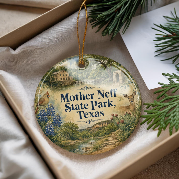 A decorative ornament with a scenic image of Mother Neff State Park, Texas, featuring a bird, deer, and various natural elements.