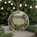 A round ornament featuring a scenic landscape of Mount Pisgah State Park in Pennsylvania, with a path leading through the forest and a waterfall in the background.