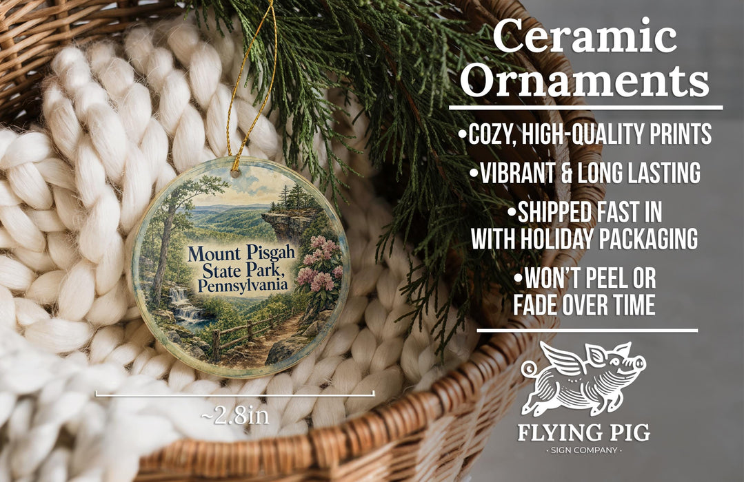 Ceramic ornaments, featuring a scenic image of Mount Pisgah State Park, Pennsylvania, hanging from a wicker basket.