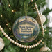 A Christmas tree decorated with ornaments, including a circular ornament with a scenic mountain landscape and text that reads "Mount Spokane State Park, Washington".