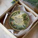A decorative ornament in a box, featuring a scenic image of a lake and a bird, with the text "Mousetail Landing State Park, Tennessee" printed on it.