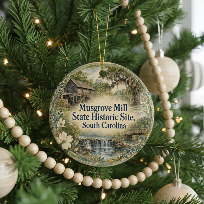 A round ornament hanging on a Christmas tree, featuring a scenic image of Musgrove Mill, South Carolina.