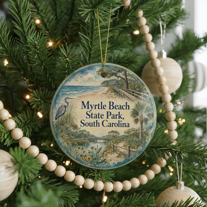 A round ornament hanging on a Christmas tree, featuring a scenic image of Myrtle Beach State Park in South Carolina.