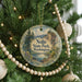 A Christmas tree decorated with ornaments, including a round ornament with a scenic landscape and the text "Nolte State Park, Washington".