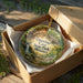 A decorative ornament in a box, featuring a scenic image of Onondaga Cave State Park in Missouri.