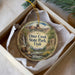A decorative ornament in a box, featuring an illustration of Otter Creek State Park in Utah.