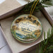 A decorative ornament with a scenic image of the Ozark Caves at Lake of the Ozarks, located in Missouri.