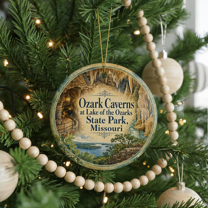 A circular ornament hanging on a Christmas tree, featuring a scenic image of the Ozark Caves at Lake of the Ozarks State Park, Missouri.