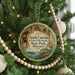 A circular ornament hanging on a Christmas tree, featuring a scenic image of the Ozark Caves at Lake of the Ozarks State Park, Missouri.