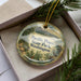 A decorative ornament with a scenic image of Pacific Pines State Park in Washington, featuring pine trees, mountains, and a bird.